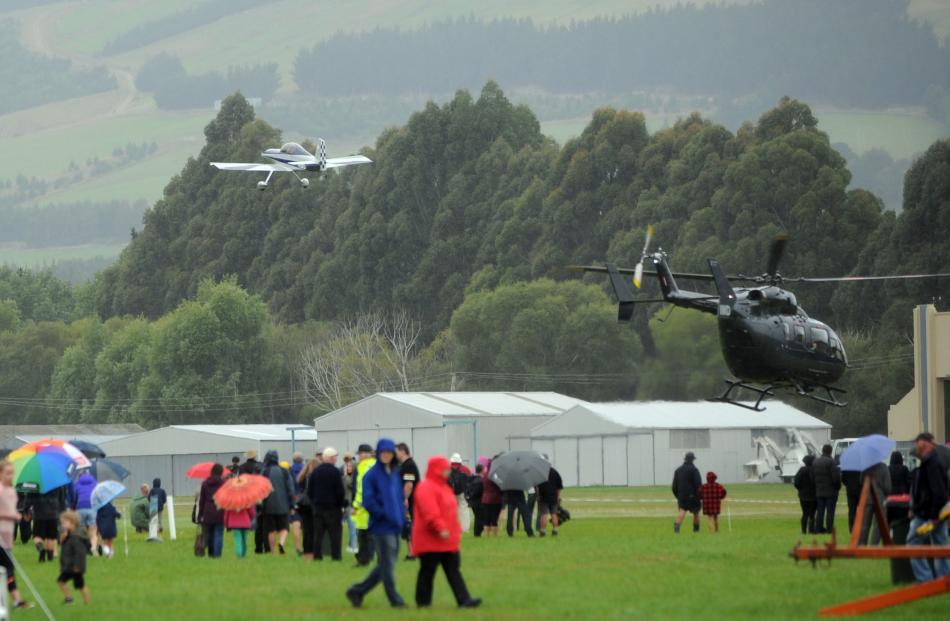 Aircraft travel overhead of spectators at the Taieri Wings and Wheels Spectacular in Mosgiel on Sunday.