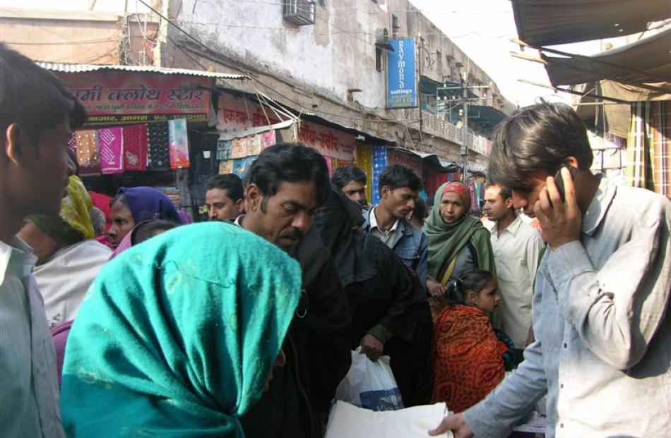 The ubiquitous modern cellphone in a traditional Indian market in Agra. Photo by Charmain Smith.