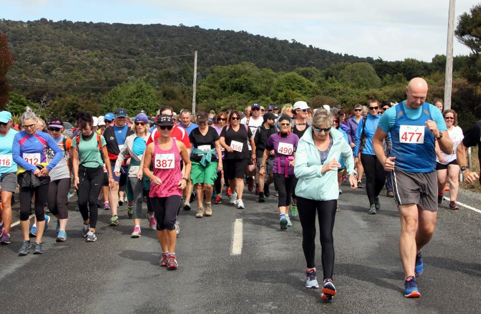 The walkers head off on their 15.5km walk in  the Papatowai Challenge on Saturday. Photos: Glenda...