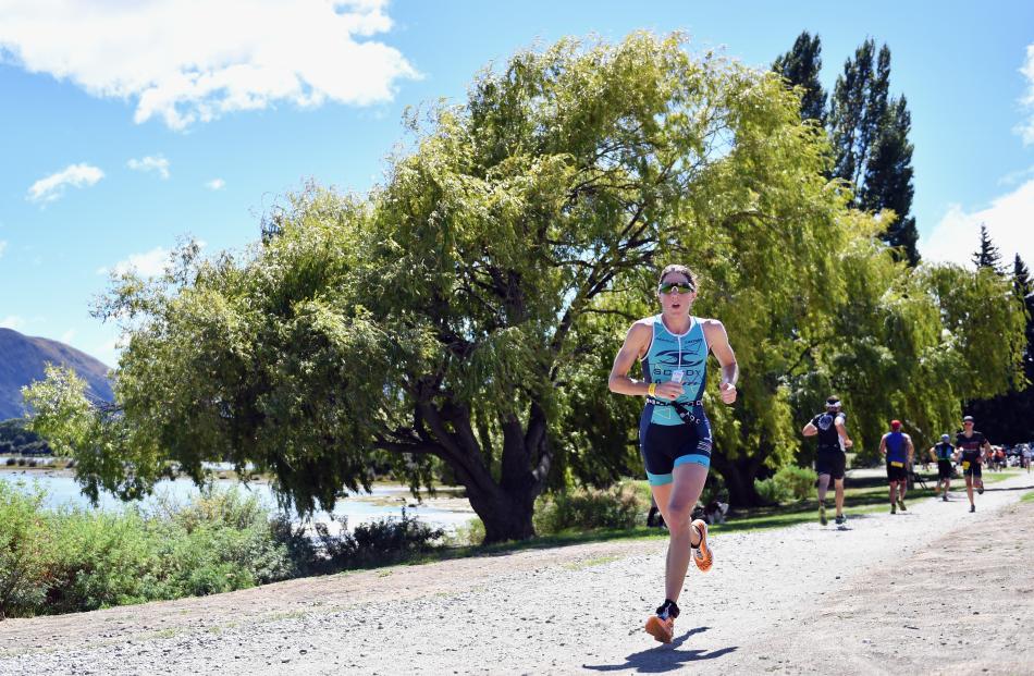 Women’s half Challenge winner Annabel Luxford, of Australia, leads the  field in the run.