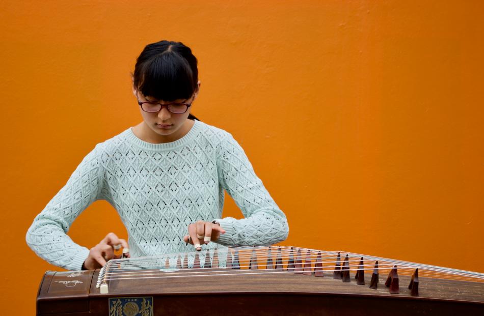 Precision plucking . . . Sophie Sun plays the Chinese zither at last year's busking festival....