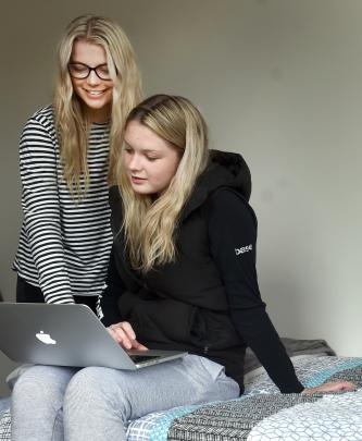 Meg Hurring (18, left) and Paige Brazier (19) surf the internet in a dorm room.