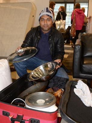 Nazmul Islam (33), from Bangladesh, fills a suitcase with a range of useful goodies. 