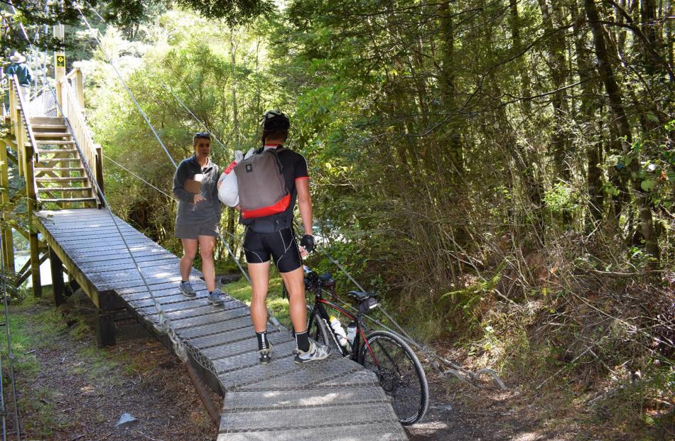 Doc ranger Yasmin Smith reminds a cyclist the track is only for walkers  and to walk the bike back out to the road.  