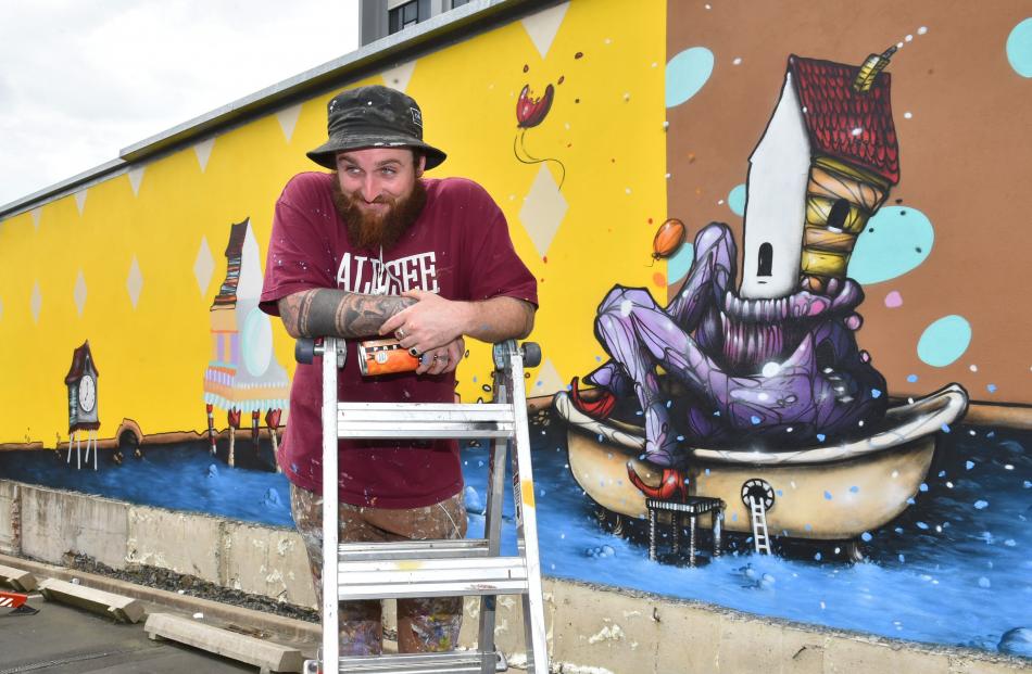 Jacob Yikes, of Christchurch, puts some of his thought processes into a mural in the car park of...