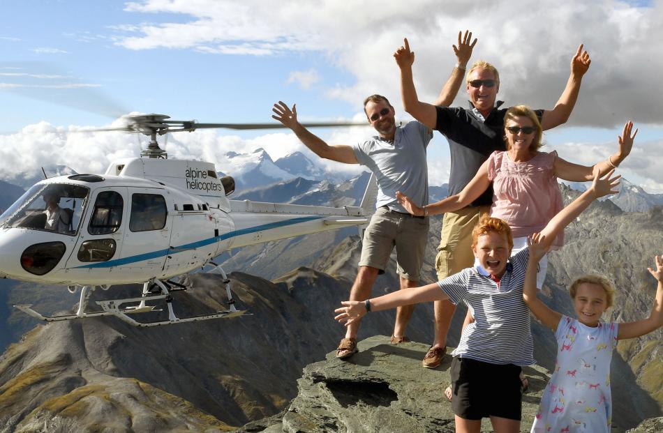 Pilot Guy Beange hovers his helicopter while (from back) Donald Carey and Ian, Judy, Freddie and Phoebe Hore, of the Maniototo, stand on Dragonfly Peak after winning an Otago Daily Times competition to guess the weight of a ram. Photos: Stephen Jaquiery