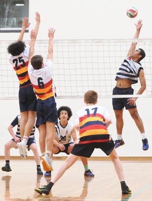 Henry Stowers (Otago Boys' High School) reaches high for the ball while team-mate Noah Rooney (centre) looks on. Lining up to defend are John McGlashan College players (from left) Mason Calvert, Will Turner and Adrian Crampton.