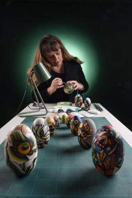 Kezia Fields spends hours painstakingly creating the designs on blank nesting dolls. Photos: Supplied