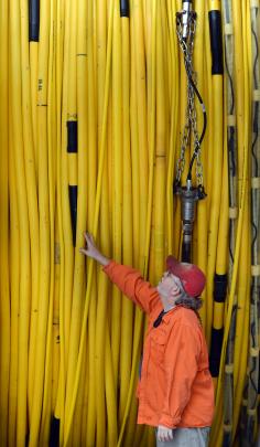 Senior science officer Robert Steinhaus inspects a streamer cable. Each streamer contains thousands of sensors which scan the ocean floor, similar to the way a CT scan works on humans.