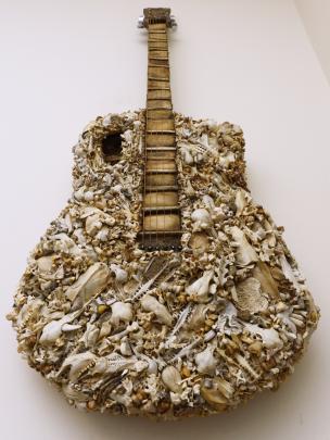 This artwork guitar can be played. It is made mainly of wood and the bones of a hedgehog, a stoat...