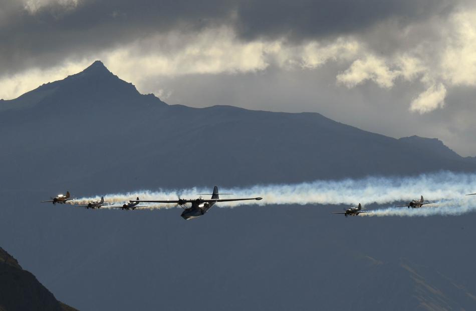 Black Peak dominates the background as the Catalina flying boat, flanked by the RNZAF Black...