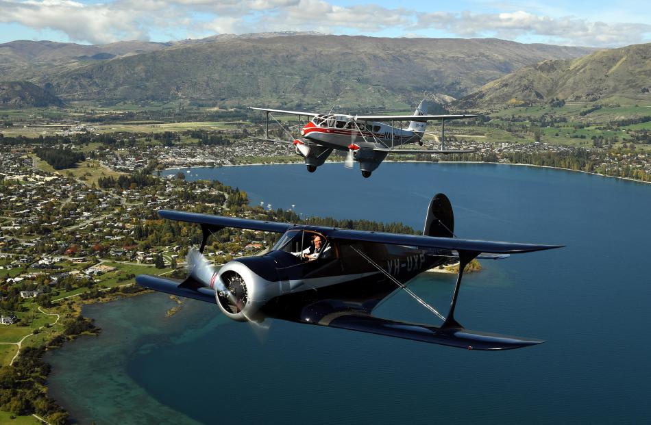 A Wanaka-based Beech Staggerwing and a de Havilland Dominie fly in formation over Lake Wanaka.