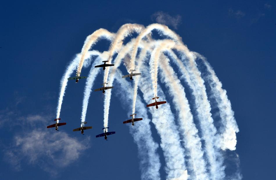 The Yak 52 team paint patterns in the sky as they perform in the feisty Russian trainer aircraft.