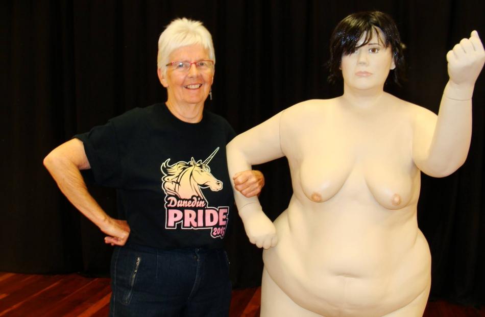 Ann Charlotte picture with Sarah Baird’s artwork at the 2015 Dunedin Pride Festival.
