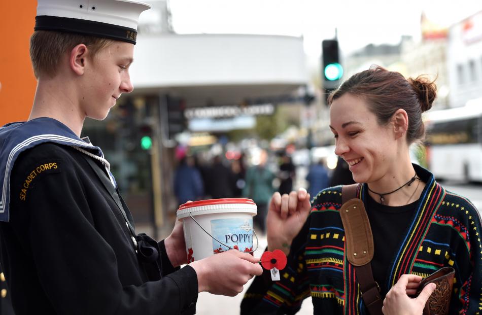 Sea Scout Corps, TS Waireka, member Kole North (15) of Dunedin passes on a poppy 
...