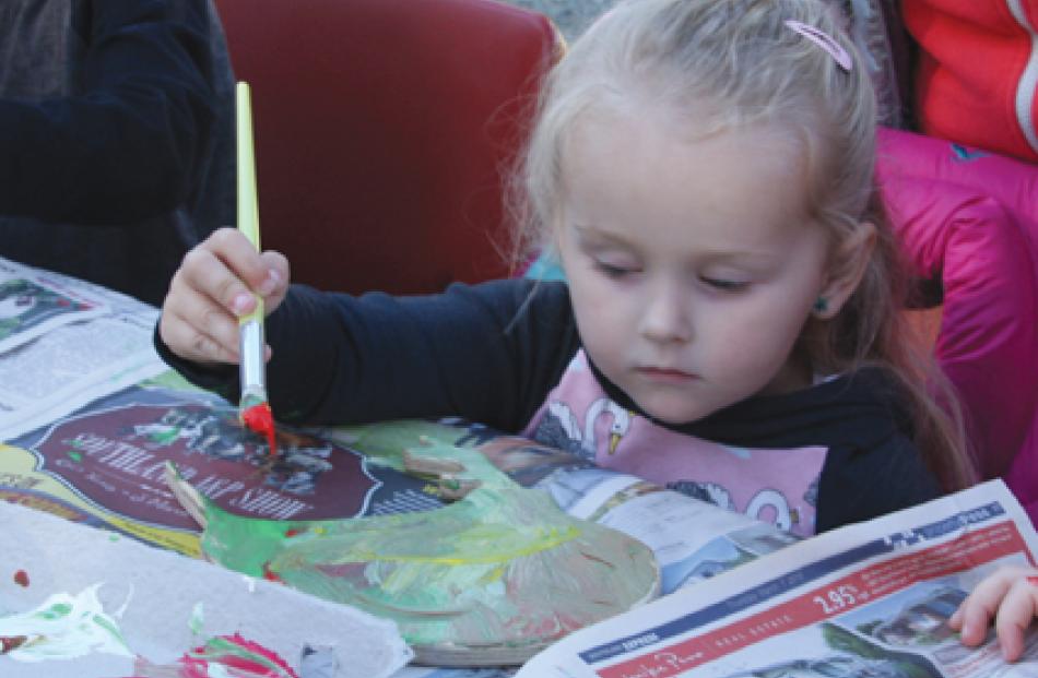 Sophie Neems (2), of Te Anau, painting a wooden takahe at the Takahe Chick Picnic. A number of...