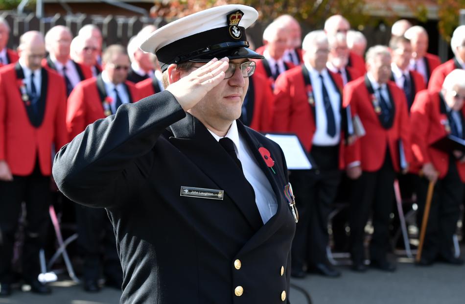 John Laughton, of HMNZS Toroa, salutes during the New Zealand national anthem at the Montecillo...