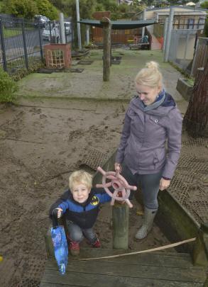 Macandrew Bay Playcentre treasurer Audrey Ross and son Liam (3) examine the flood damage to the...