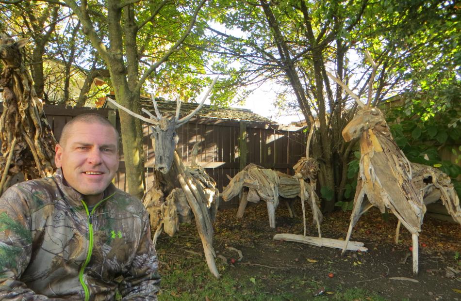 Greg Powell, of Lowcliffe, and some of the menagerie he has created from driftwood. Photo: Toni...