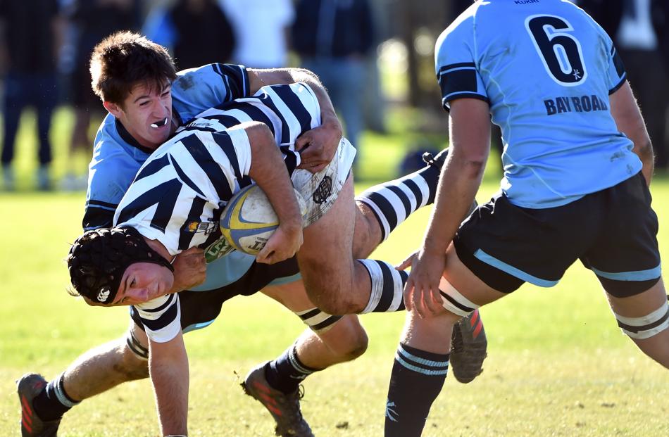 Otago Boys’ High School First XV hooker Harry Hansen gets tackled by King’s High School First XV lock Sam Stewart with flanker Sabin Reynolds in support during the traditional interschool fixture yesterday. Photos: Peter McIntosh