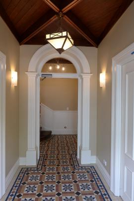 The arch and ceiling in the entrance foyer are original features. Fitting a fire-stop door...