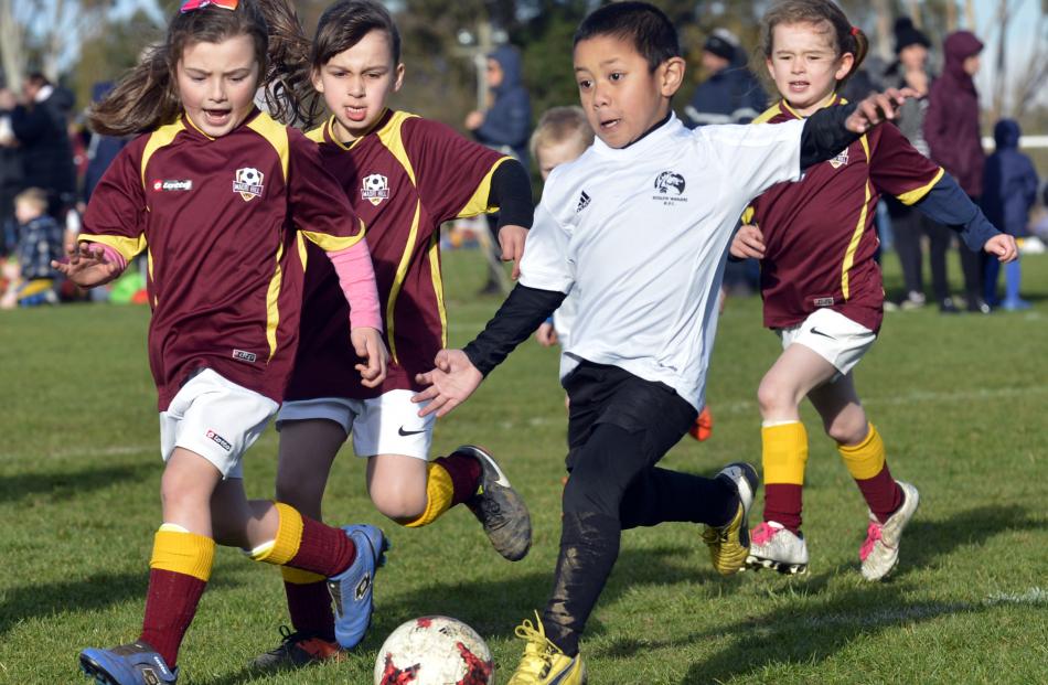 Maori Hill 6th Maroon players  Ava Couling (left), Olivia McIntyre and Alice Ussher try to take...