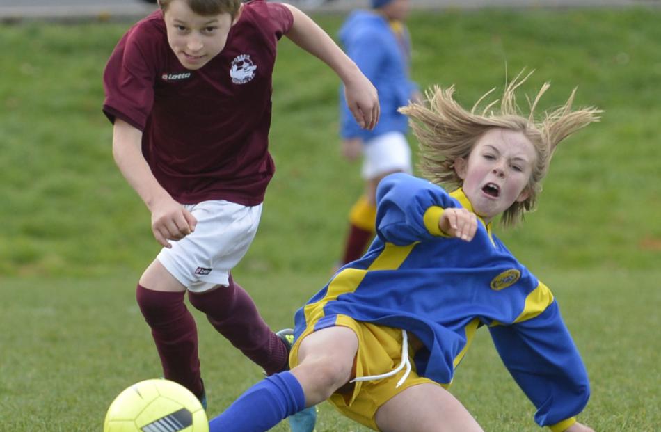 Melchester Rovers player Charlotte Summers (8) dives to get to the ball ahead of Dunedin Tech...