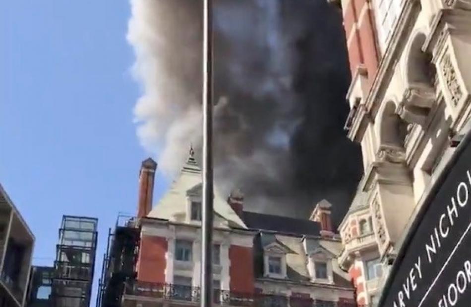 A blaze is seen at the Mandarin Oriental Hotel in Knightsbridge, London. Photo: Twitter/@MattheWickens/via Reuters