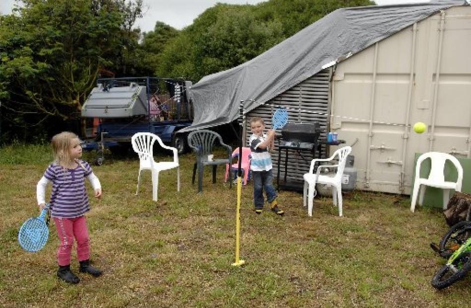 Clair and Ben Wild (4), of Dunedin, play outside their makeshift holiday home at Aramoana.