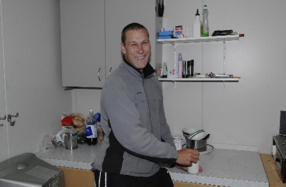 David Wild, of Dunedin, make a hot drink on a cold day at Aramoana.