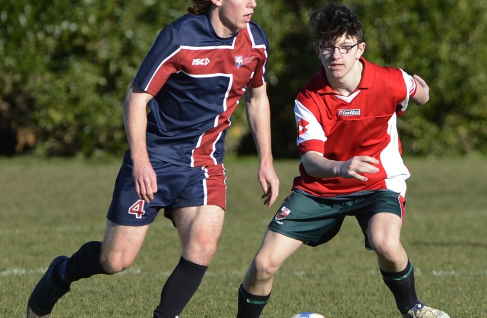 Tim O'Farrell (Kavanagh College) is challenged by Riley Dasler (Kaikorai Valley College) during a...