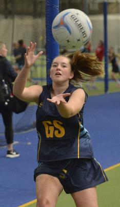 Taieri College goal shoot Jaci Lambie reels in a pass during a netball match against Kavanagh...