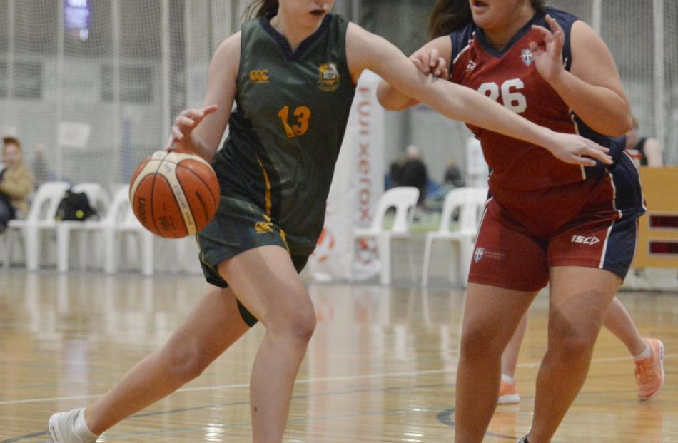Kashya Arras-Scott  Bayfield High School) brushes past Nadia Uriaro (Kavanagh College) during a...