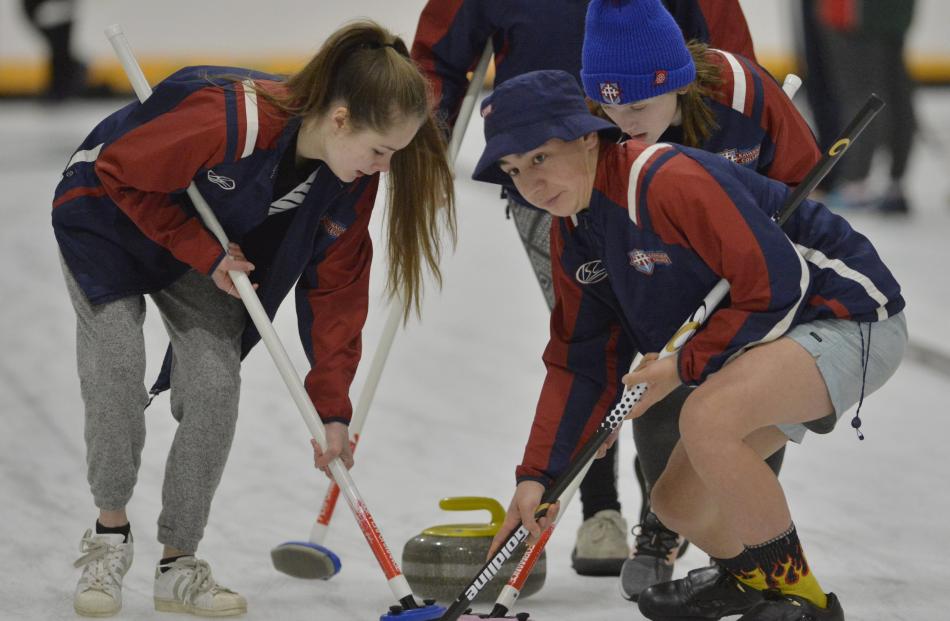 Kavanagh College curlers (from left ) Emily Armstrong , Jayden Bishop and Elizabeth Audas sweep...