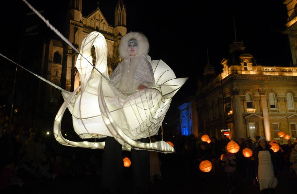 Stilt walker, Mary Cocker, from Dunedin appears to be floating in mid-air in the mid-winter...