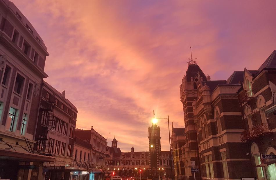 The sun rises over the Dunedin Railway Station. Photo: Vaughan Elder