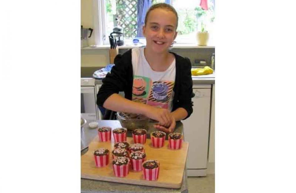 Busy on a wet day, The photographer's granddaughter,Emma Taggart (11) making cup-cakes at the...