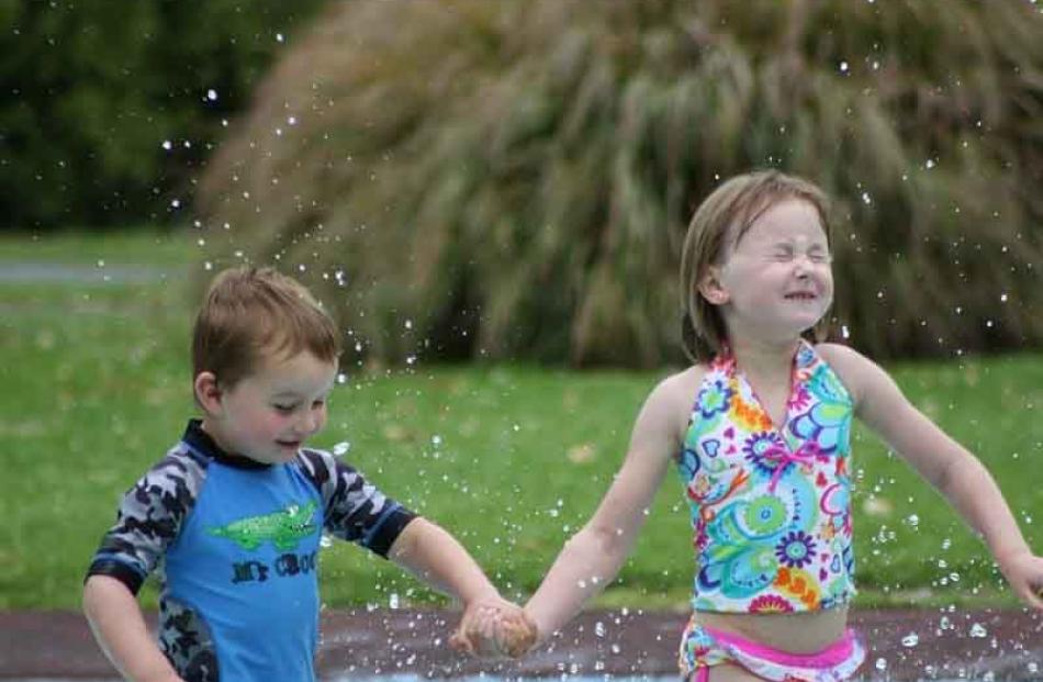 Splish splash . . . Keiran Petrie (3) and Caitlyn Petrie (6) at Woodhaugh Gardens on December 30....