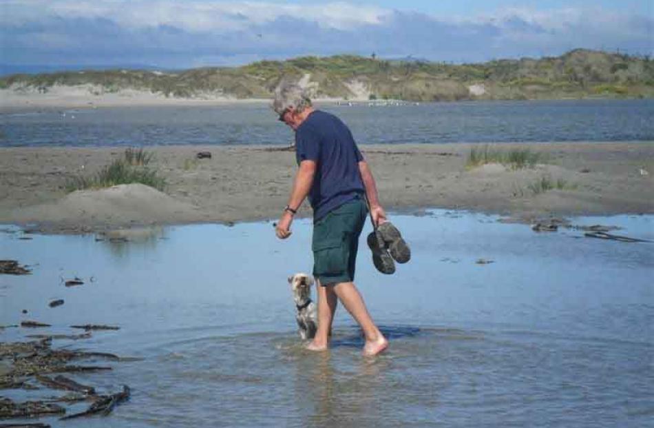 Every man . . . Kevin Mason and his dog Ozzy at Waldronville beach on Christmas Day. Photo: Val...