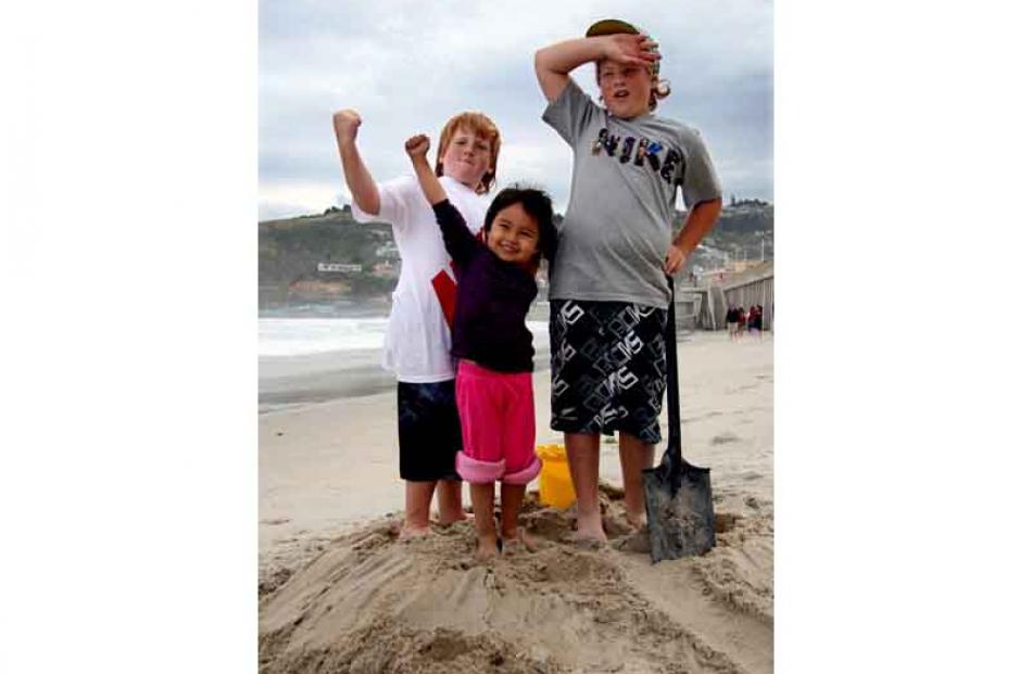 High ground . . . Cousins Caleb Shaw (9), Maya Satake (3) and Quinn Shaw (12) at St Clair beach...