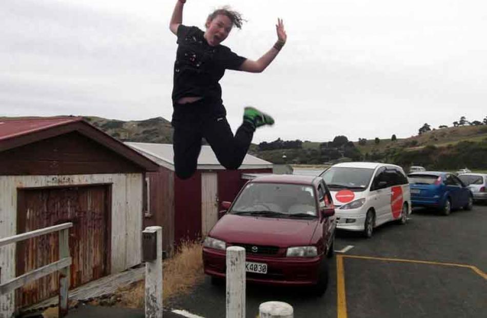 Pierhead jump . . . Breeana Richardson (14) entertains herself at Wellers Rock while waiting for...