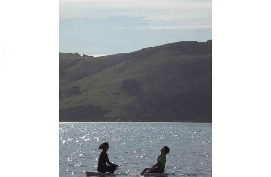Wet silhouettes . . . Step-siblings Brittney Mcintosh (13) and Jack Verhoef (11) have fun near...