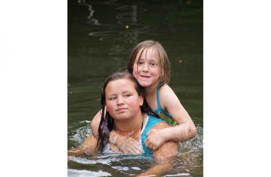 In depth . . . Paige Church (14) and Jamie Church (8) in the Shag River at Dunback domain. Photo:...