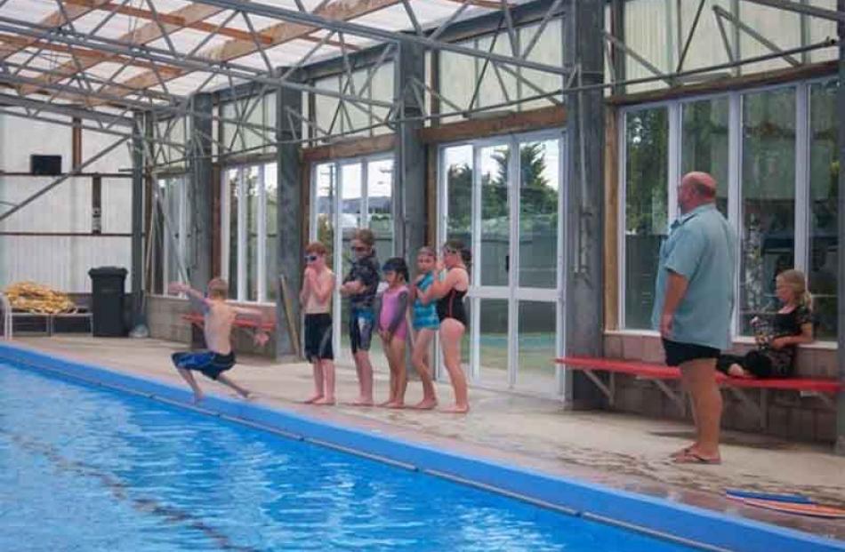 Harry Brenssell 9yrs jumping in backwards to do backstroke. Swimming lessons with Graham Laing at...
