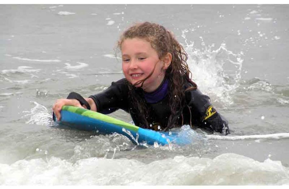 Here are some photos of Jenna Paterson (7) surfing the waves at Brighton Beach. Photos were...
