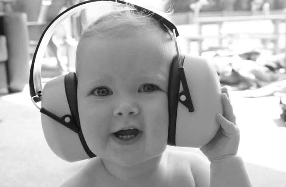 Health and safety . . . Libby Begg (16 months) on Christmas Day with her new earmuffs for wearing...