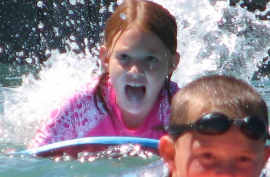 Amber Mowat (8) racing her cousin Caleb Mowat from Australia from the pontoon into the shore at...