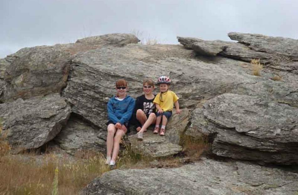 Rail trail trio . . . Rebecca McNaughton (12), Sarah McNaughton (10) and Sophie Low (3) rest on...