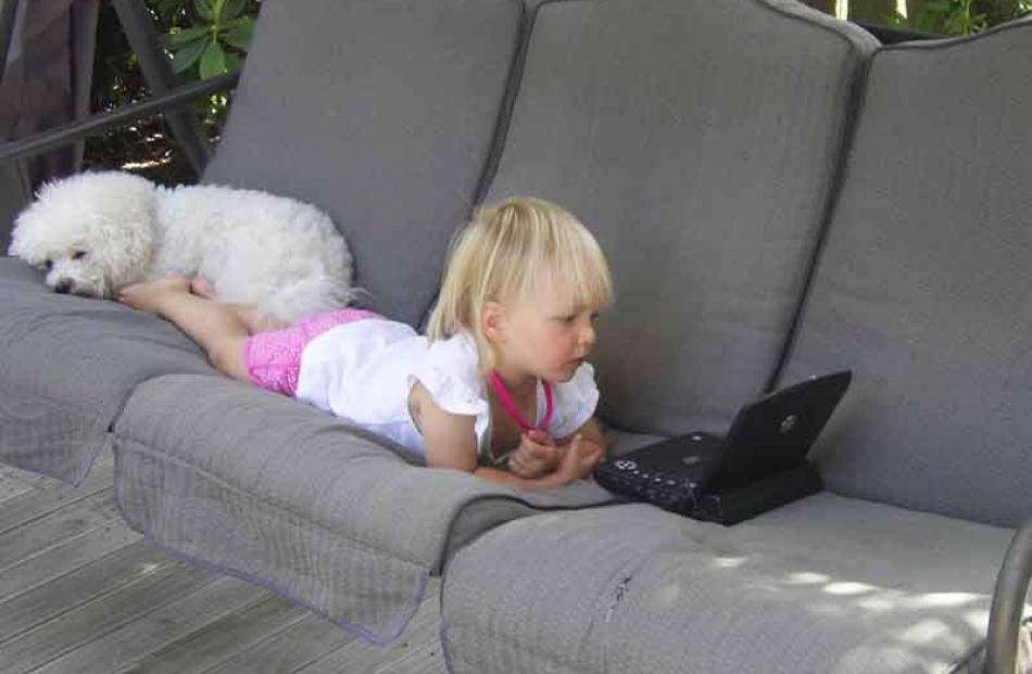 Tayla Ashton (2) and Giselle the bichon relax at the fammily crib in Naseby on January 4. Photo:...