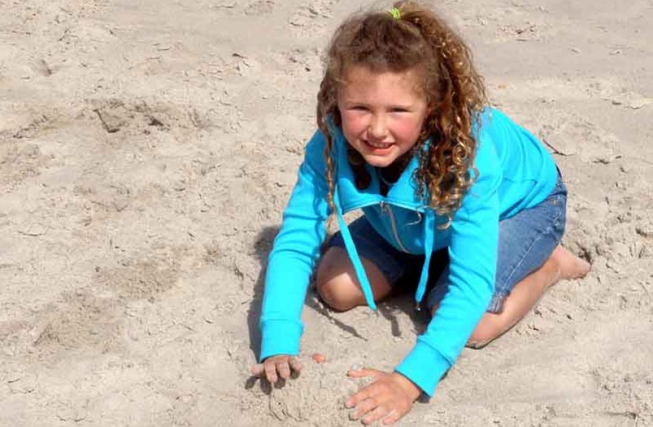 Jenna Paterson (7) playing in the sand at St Clair beach. Photo taken by Glenda Paterson.